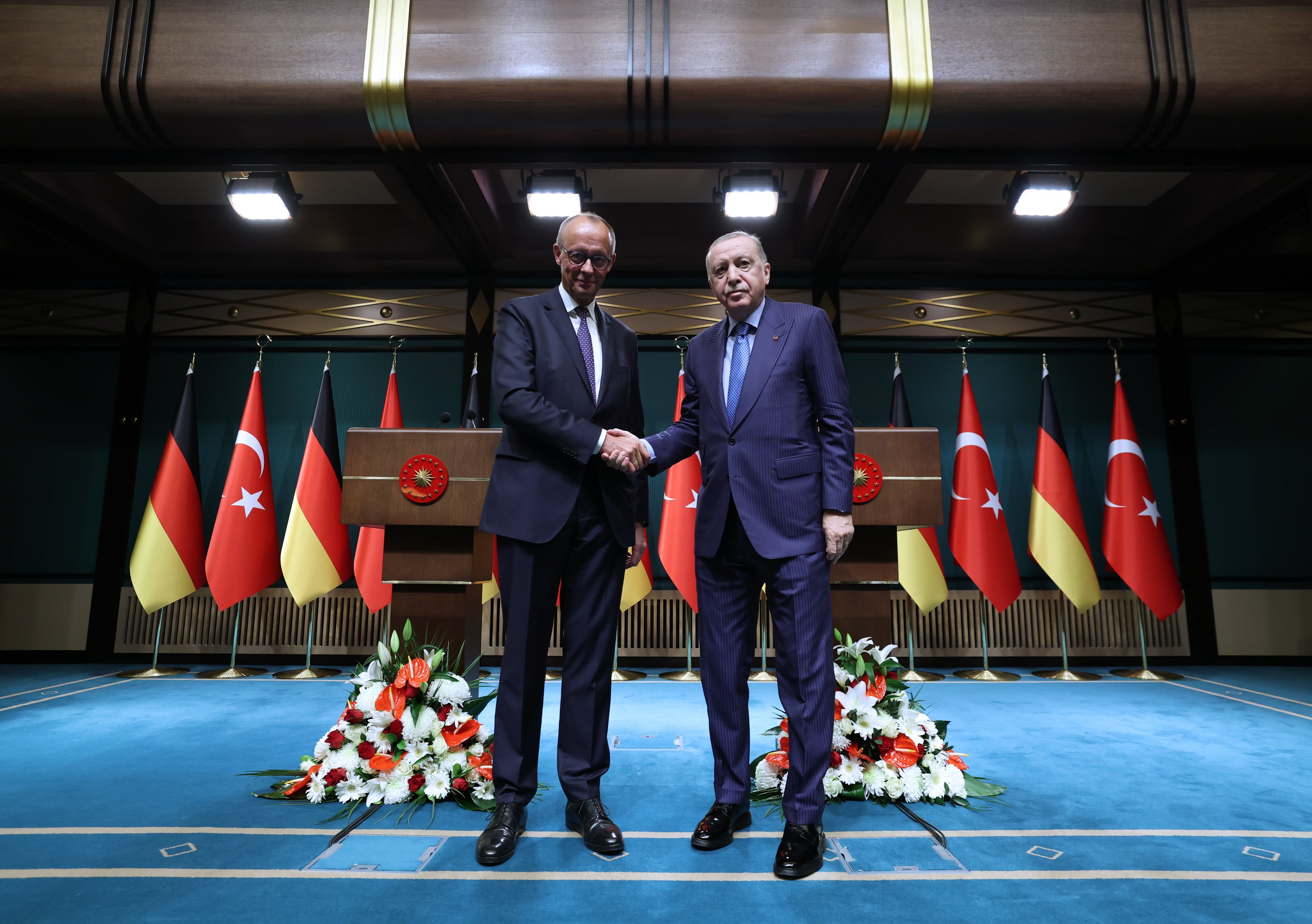 İŞ GÜCÜ ANLAŞMASININ 64. YILI HATIRLANDI
Erdoğan, görüşmede Türkiye ile Batı Almanya arasında 1961 yılında imzalanan İş Gücü Anlaşması’nın 64’üncü yıl dönümüne de değindi. Almanya’ya giden ilk nesil Türk işçilerin, bugün 3,5 milyona ulaşan nüfuslarıyla Almanya’nın kalkınmasına önemli katkılar sunduğunu söyledi.
Cumhurbaşkanı Erdoğan, Almanya’daki Türk toplumunun iki ülke arasındaki ilişkilerin temel unsurlarından biri olduğunu vurguladı ve bu topluluğun yıllar içinde elde ettiği kazanımların korunmasına verdikleri önemin altını çizdi.
TİCARET HACMİNDE HEDEF 60 MİLYAR DOLAR
Türkiye ile Almanya arasındaki ekonomik ilişkilerin olumlu seyrini sürdürdüğünü belirten Cumhurbaşkanı Erdoğan, iki ülke arasındaki ticaret hacminin 50 milyar dolara ulaştığını ve kısa vadede bu rakamın 60 milyar dolara çıkarılmasının hedeflendiğini ifade etti.